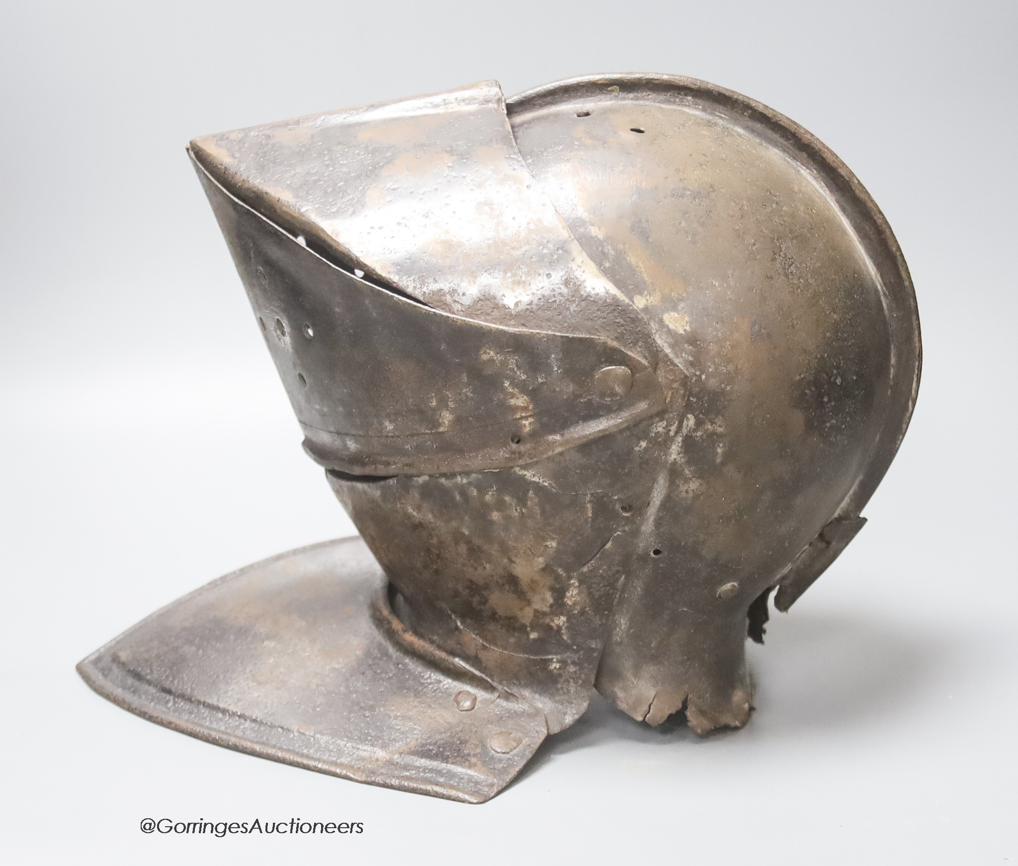 A 17th century iron close helmet, height 28cm approx.